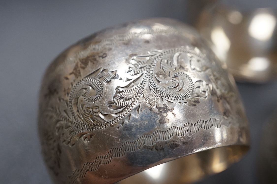 A George V silver sauceboat, with flying scroll handle, Jay, Richard Attenborough Co Ltd, Sheffield, 1925, together with a set of four Edwardian silver napkin rings, 11.3oz.